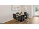 Modern dining area with a sleek glass table, black chairs, and elegant decor at 179 Stanchion Dr, Union City, GA 30291