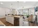 Open concept living, with kitchen island, modern appliances, and view to the living room at 179 Stanchion Dr, Union City, GA 30291