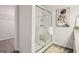 Modern bathroom shower with glass doors and elegant fixtures, and decorative painting at 179 Stanchion Dr, Union City, GA 30291