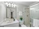 Bathroom with a white vanity, glass shower and tile accents; note the framed mirror at 125 Franklin Pl, Atlanta, GA 30342