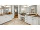 Bright bathroom featuring double sinks, granite countertops, white cabinetry, and a makeup vanity at 125 Franklin Pl, Atlanta, GA 30342
