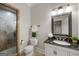 Modern bathroom featuring a white vanity, dark countertop, framed mirror, and glass enclosed shower at 125 Franklin Pl, Atlanta, GA 30342