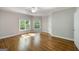Bedroom featuring hardwood floors, neutral walls, and large windows for ample natural light at 125 Franklin Pl, Atlanta, GA 30342