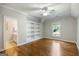 Well lit bedroom with wood floors, ceiling fan, built in shelves and a window overlooking the backyard at 125 Franklin Pl, Atlanta, GA 30342