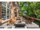 Expansive wooden deck with comfortable seating, dining area, and beautiful backyard views, perfect for outdoor enjoyment at 125 Franklin Pl, Atlanta, GA 30342