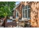 Spacious deck features outdoor seating, a dining area, and a charming brick exterior for relaxing and entertaining at 125 Franklin Pl, Atlanta, GA 30342