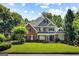 Stately brick and gray home with lush green lawn, offering classic curb appeal and mature landscaping at 125 Franklin Pl, Atlanta, GA 30342