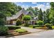 Charming home featuring manicured landscaping and a circular driveway, enhancing its inviting curb appeal at 125 Franklin Pl, Atlanta, GA 30342