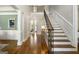 Spacious foyer with hardwood floors, staircase, and stylish decor, leading into other areas of the home at 125 Franklin Pl, Atlanta, GA 30342