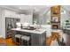 Stylish kitchen with marble countertops, gray island with seating, and a stone fireplace feature in the background at 125 Franklin Pl, Atlanta, GA 30342