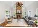 Warm living room featuring a floor-to-ceiling stone fireplace, high ceiling, and comfortable seating arrangement at 125 Franklin Pl, Atlanta, GA 30342