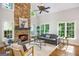 Cozy living room with stone fireplace, hardwood floors, natural light, and comfortable furniture arrangement at 125 Franklin Pl, Atlanta, GA 30342