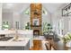 Inviting living room showcasing a stone fireplace, large windows, hardwood floors, and open kitchen access at 125 Franklin Pl, Atlanta, GA 30342