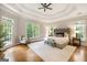 Spacious main bedroom with tray ceiling, hardwood floors, and large windows offering ample natural light at 125 Franklin Pl, Atlanta, GA 30342