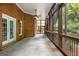 Large screened porch featuring a ceiling fan, brick wall, and access to the outdoor area, perfect for relaxation at 125 Franklin Pl, Atlanta, GA 30342