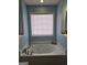 Relaxing bathroom featuring a large jacuzzi tub and natural light from a window at 946 Creek Run Pl, Temple, GA 30179