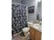 This bathroom features a vanity with storage and a shower/tub combo with curtain at 946 Creek Run Pl, Temple, GA 30179