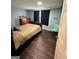 Bedroom with neutral walls, dark floors, a wood dresser and a ceiling fan at 946 Creek Run Pl, Temple, GA 30179