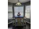 Charming breakfast nook features a rustic table with seating, brightened by natural light from surrounding windows at 946 Creek Run Pl, Temple, GA 30179