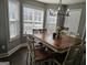Elegant dining room showcasing a wooden table and chairs, complemented by natural light through the windows at 946 Creek Run Pl, Temple, GA 30179