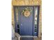 Close-up of the stylish front door, highlighted by a Gathering name decoration and surrounded by stone accents at 946 Creek Run Pl, Temple, GA 30179