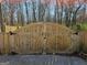 Sturdy wooden gate providing backyard access and security, enhancing the property's curb appeal and privacy at 946 Creek Run Pl, Temple, GA 30179