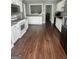 Large kitchen with white cabinets, stainless steel appliances, and dark wood flooring at 946 Creek Run Pl, Temple, GA 30179