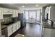 Spacious kitchen featuring white cabinetry and a breakfast nook with ample natural light at 946 Creek Run Pl, Temple, GA 30179