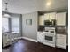 Kitchen with white cabinets, stainless steel appliances, and a cozy breakfast bar at 946 Creek Run Pl, Temple, GA 30179