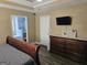Well-lit main bedroom featuring a bed, a dresser, and a view into the bathroom at 946 Creek Run Pl, Temple, GA 30179