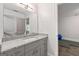 Bathroom featuring a granite countertop, white sink, and gray cabinetry at 145 Mount Shasta Ln, Johns Creek, GA 30022