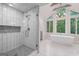Bright bathroom boasts a glass shower, stand alone tub, large windows and modern fixtures at 145 Mount Shasta Ln, Johns Creek, GA 30022