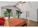 Bright bedroom features vaulted ceilings, hardwood floors, and sliding doors to an outdoor deck at 145 Mount Shasta Ln, Johns Creek, GA 30022