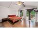 Bright bedroom features vaulted ceilings, hardwood floors, and sliding doors to an outdoor deck at 145 Mount Shasta Ln, Johns Creek, GA 30022