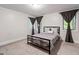 Simple bedroom featuring natural light, plush carpet, and a comfortable bed at 145 Mount Shasta Ln, Johns Creek, GA 30022