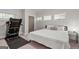 Bright bedroom featuring a treadmill, plush carpet, and a comfortable bed at 145 Mount Shasta Ln, Johns Creek, GA 30022