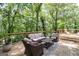 Outdoor deck featuring comfortable seating and lush green surroundings at 145 Mount Shasta Ln, Johns Creek, GA 30022