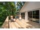 Deck area with lounge chairs and view of lush trees at 145 Mount Shasta Ln, Johns Creek, GA 30022