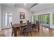 Bright dining room with hardwood floors, large windows, and a table set for six at 145 Mount Shasta Ln, Johns Creek, GA 30022