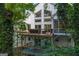 Exterior view featuring multi-level decks and large windows overlooking the wooded landscape at 145 Mount Shasta Ln, Johns Creek, GA 30022