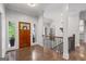 Welcoming foyer with hardwood floors, a wooden front door, and staircase to the second level at 145 Mount Shasta Ln, Johns Creek, GA 30022