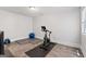 Gym with gray mat, exercise bike, weights and bright natural light from a window at 145 Mount Shasta Ln, Johns Creek, GA 30022