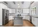 Stylish kitchen with a gray center island, stainless steel appliances, and white cabinets at 145 Mount Shasta Ln, Johns Creek, GA 30022