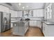 Modern kitchen with white cabinets, stainless steel appliances, and granite countertops at 145 Mount Shasta Ln, Johns Creek, GA 30022