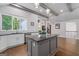 The kitchen has a granite island, and stainless appliances, with a hardwood floor at 145 Mount Shasta Ln, Johns Creek, GA 30022