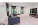 Spacious living room with natural light, featuring a comfortable sofa and entertainment center at 145 Mount Shasta Ln, Johns Creek, GA 30022