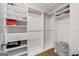 Spacious walk-in closet features built-in shelving and ample storage space for clothing and accessories at 145 Mount Shasta Ln, Johns Creek, GA 30022