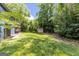 Lush backyard featuring a well-maintained lawn and a storage shed, offering space and utility at 178 Castleair Ne Dr, Kennesaw, GA 30144