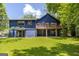 View of the backyard and back of the house, showcasing a deck and outdoor living space at 178 Castleair Ne Dr, Kennesaw, GA 30144