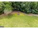 Spacious backyard featuring a fire pit and lush greenery, ideal for outdoor gatherings at 178 Castleair Ne Dr, Kennesaw, GA 30144